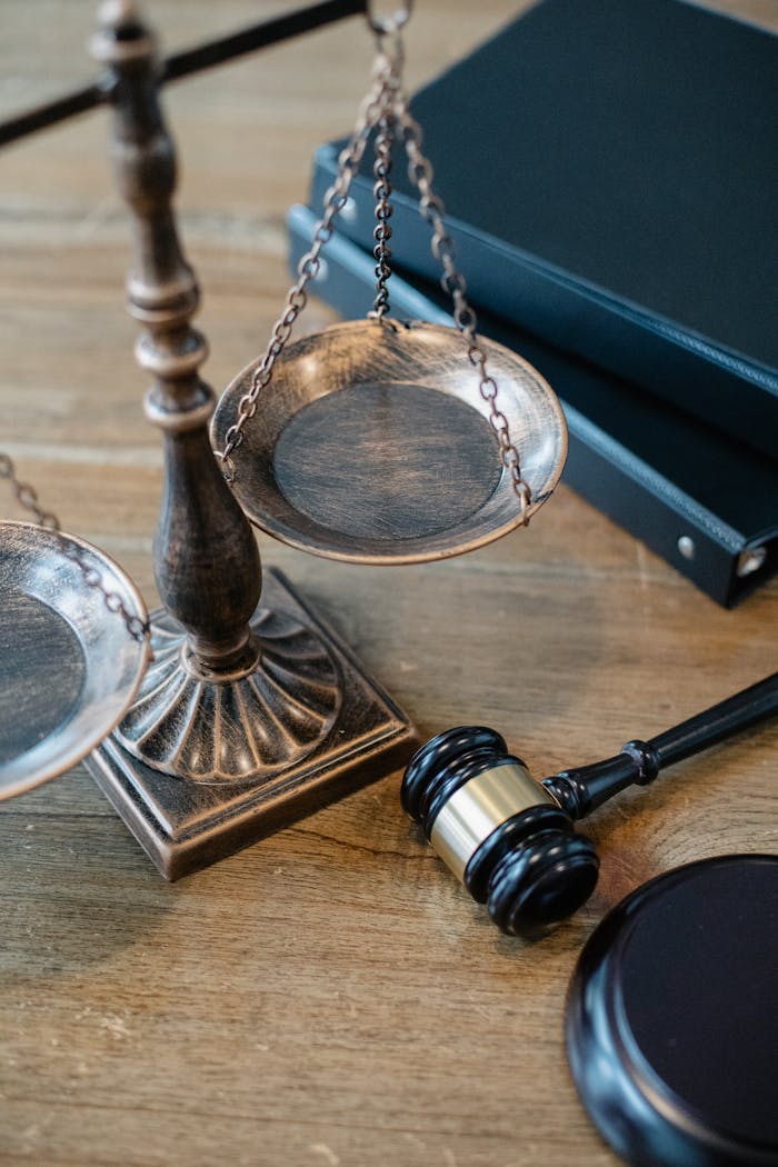 about-us From above of judicial symbols consisting of Scales of Justice and small judge hammer with curly handle
